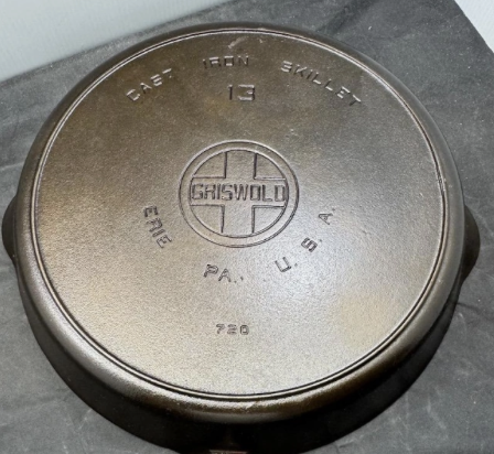 Vintage Griswold large block logo number 13 cast iron skillet with heat ring, pattern number 720. Noted to have a "2-card" wobble (meaning that placing two business cards beneath the uneven part of the bottom stops the wobble). Sold for $3,300.